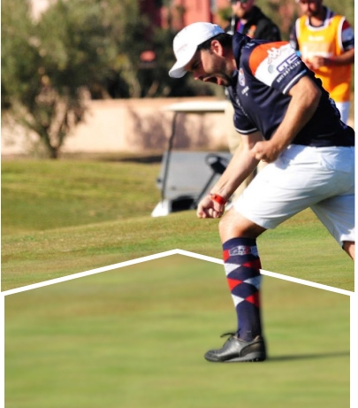 A player celebrating on the field as others watch in the background.